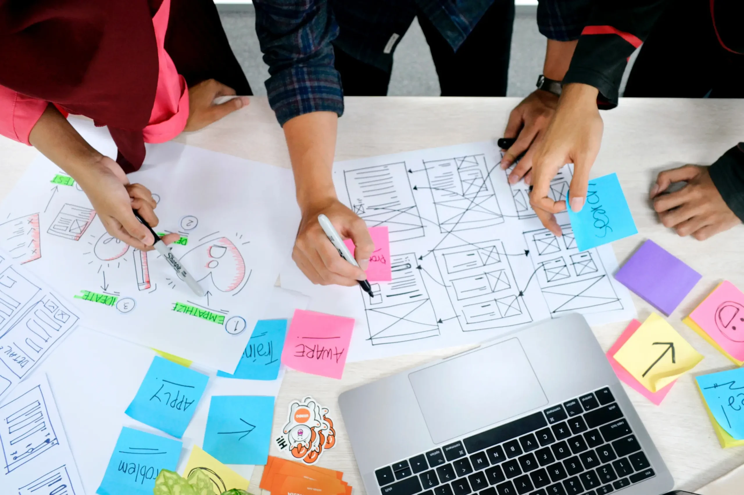 several people working on a website creation project together at a table